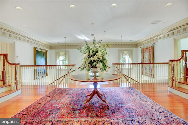 interior space featuring light wood-type flooring, crown molding, and a wealth of natural light