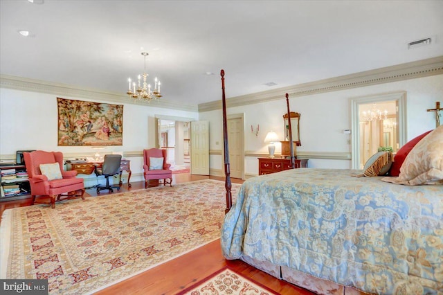 bedroom with a chandelier, wood-type flooring, and crown molding