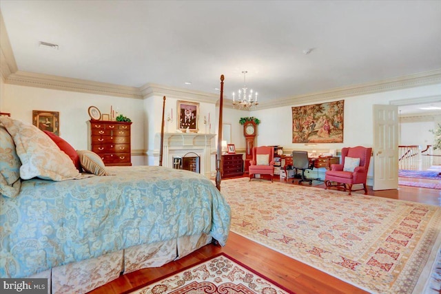 bedroom with wood-type flooring, a notable chandelier, and ornamental molding