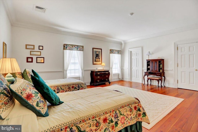 bedroom featuring wood-type flooring and crown molding