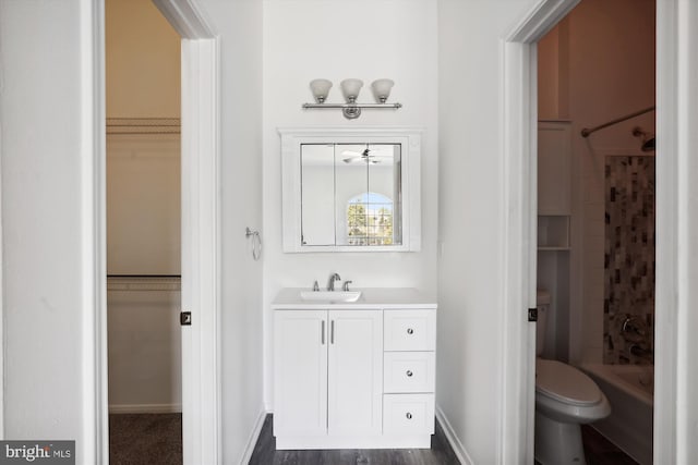 full bathroom with shower / tub combo, vanity, toilet, and hardwood / wood-style flooring