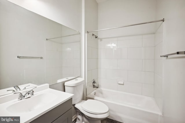 full bathroom with vanity, tiled shower / bath combo, and toilet