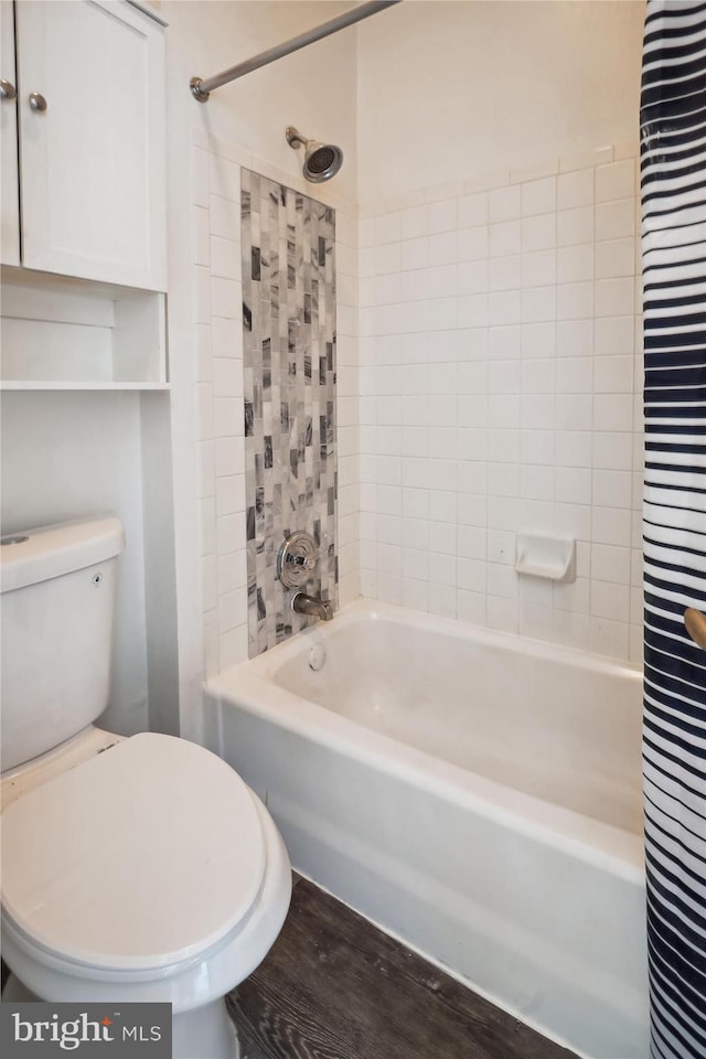 bathroom featuring shower / tub combo, toilet, and hardwood / wood-style flooring