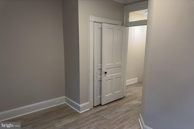 corridor with light hardwood / wood-style flooring