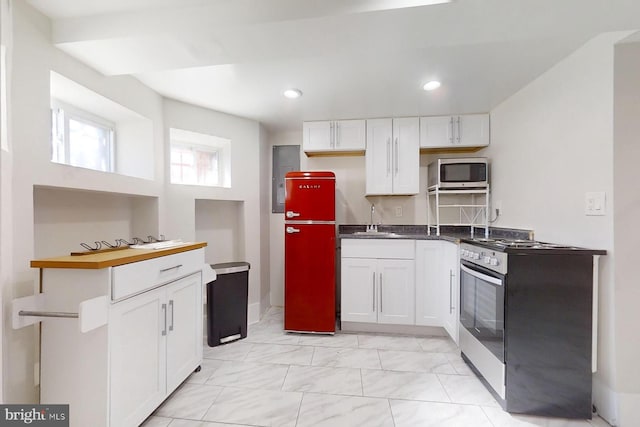 kitchen featuring white cabinets, stainless steel appliances, and sink