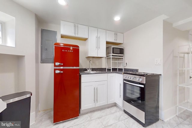 kitchen with electric panel, sink, white cabinets, and appliances with stainless steel finishes