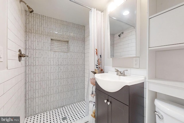 bathroom featuring vanity, toilet, and curtained shower