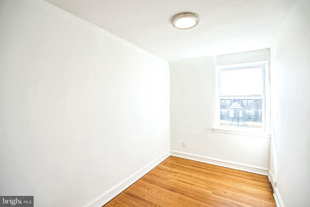 unfurnished room featuring baseboards and light wood finished floors