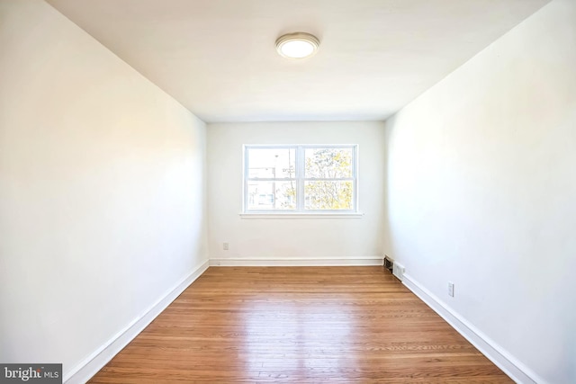 spare room with hardwood / wood-style floors