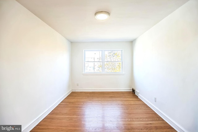 empty room with wood finished floors and baseboards