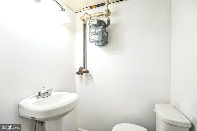 bathroom with toilet and a sink