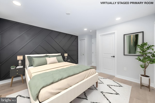 bedroom featuring wooden walls and light hardwood / wood-style floors