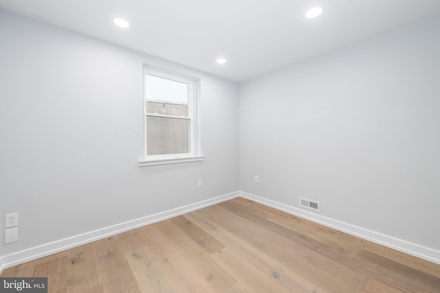 spare room with light hardwood / wood-style flooring