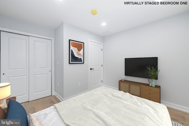 bedroom featuring a closet and light wood-type flooring