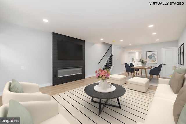 living room with a fireplace and light hardwood / wood-style floors