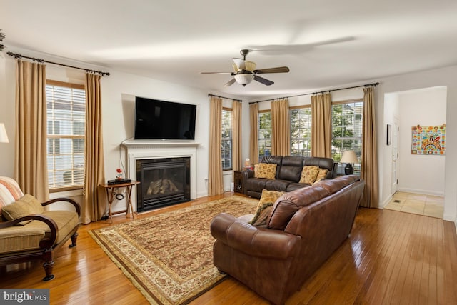 living room with hardwood / wood-style floors and ceiling fan