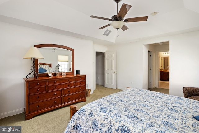 bedroom featuring light carpet, ceiling fan, and a tray ceiling