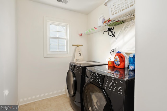 washroom featuring separate washer and dryer and light tile patterned flooring