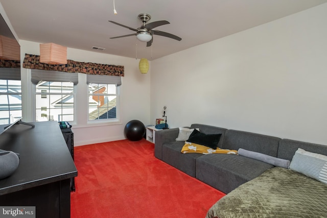 carpeted living room with ceiling fan