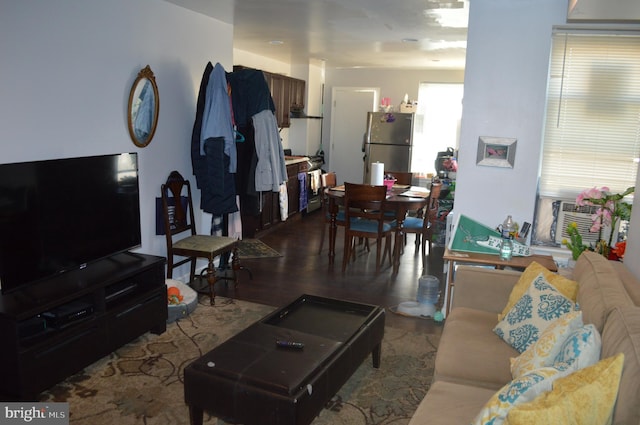 living room with cooling unit and wood-type flooring