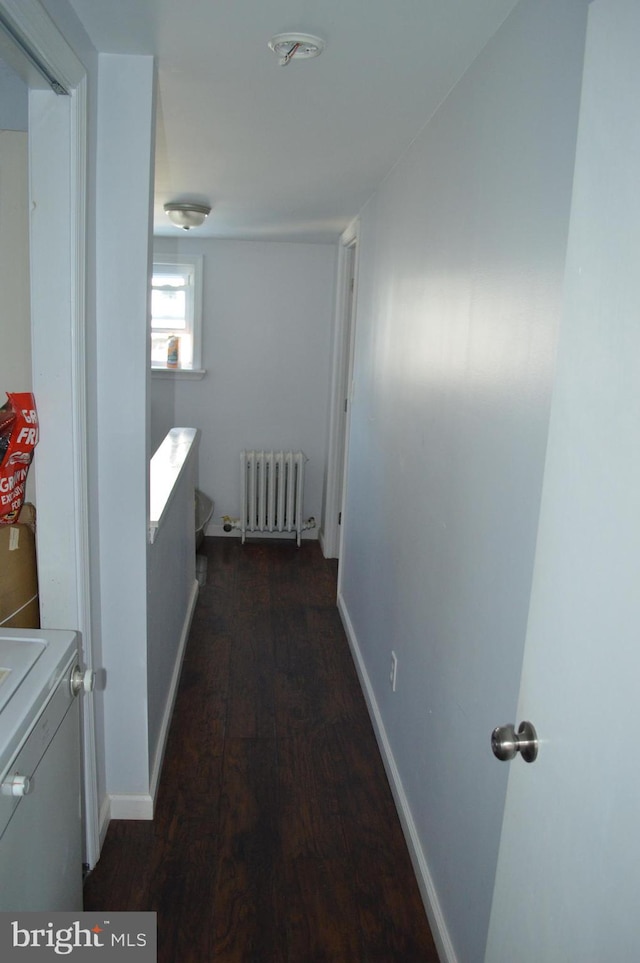 hallway with dark hardwood / wood-style floors and radiator