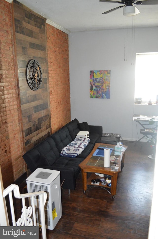 living room featuring brick wall, dark wood-type flooring, and ceiling fan