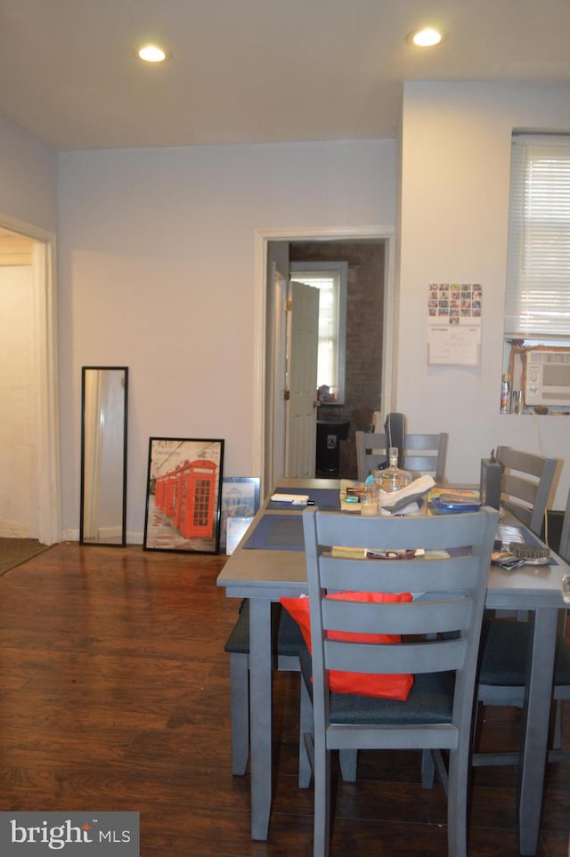 dining space with dark hardwood / wood-style flooring