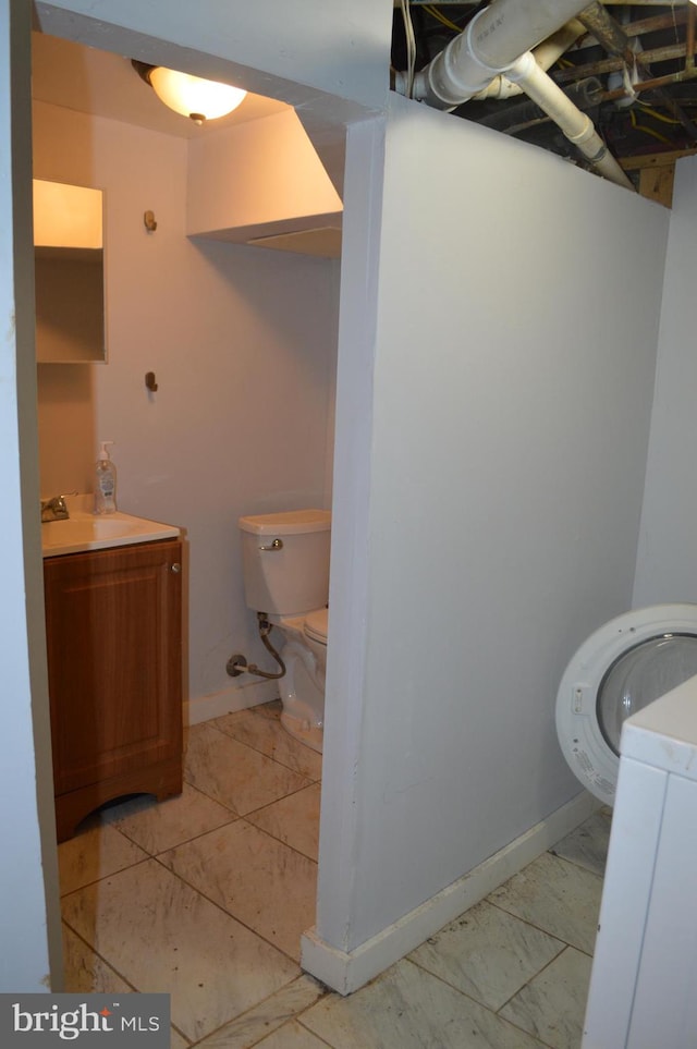 bathroom featuring toilet, vanity, and tile patterned floors