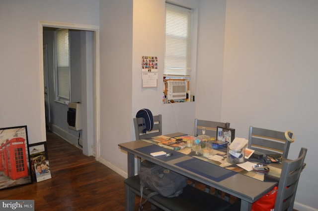 dining space with cooling unit, dark hardwood / wood-style floors, and heating unit