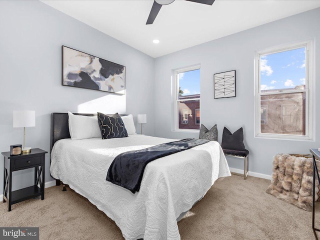 bedroom featuring ceiling fan and light carpet