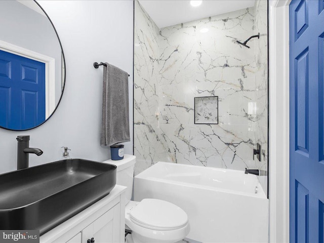 full bathroom with vanity, tiled shower / bath combo, and toilet