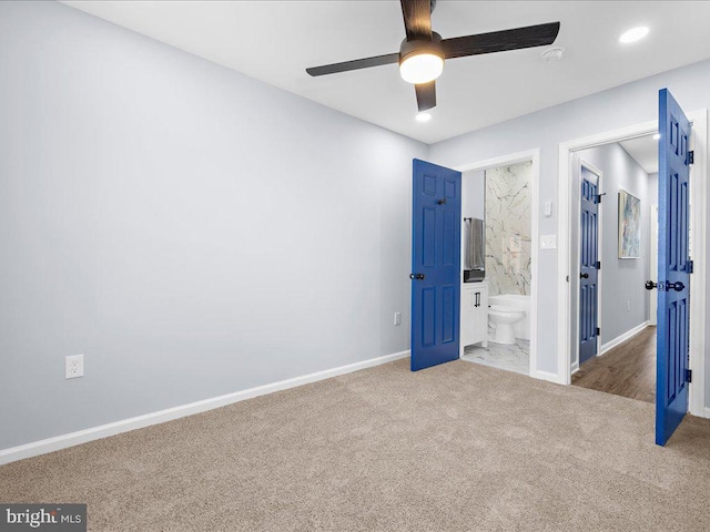 unfurnished bedroom with carpet floors, connected bathroom, and ceiling fan