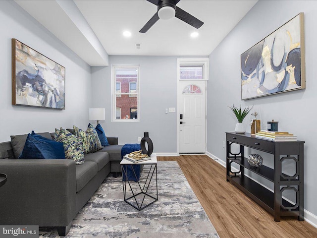 living room featuring hardwood / wood-style flooring and ceiling fan