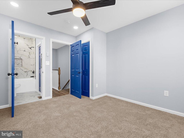 unfurnished bedroom with ensuite bathroom, ceiling fan, and light carpet