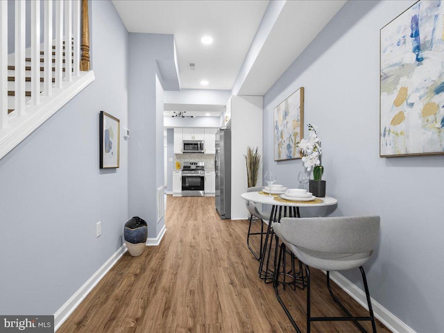 hallway featuring hardwood / wood-style flooring