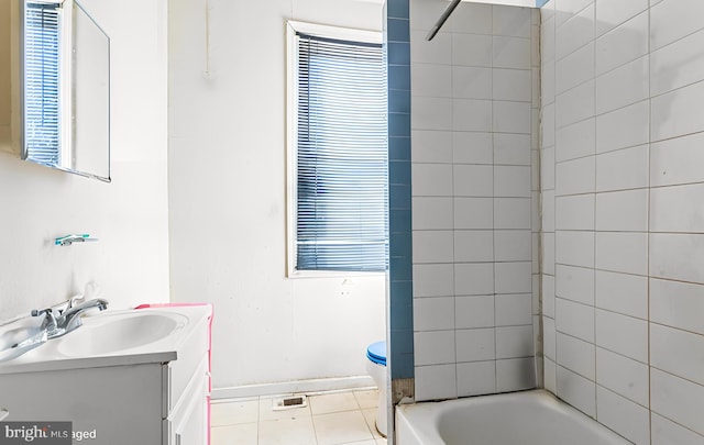 full bathroom with vanity, tiled shower / bath combo, toilet, and tile patterned flooring