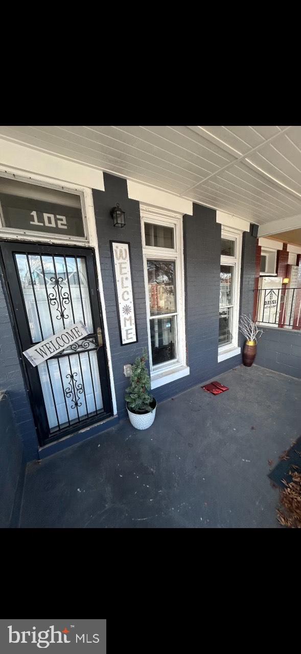 doorway to property featuring a porch