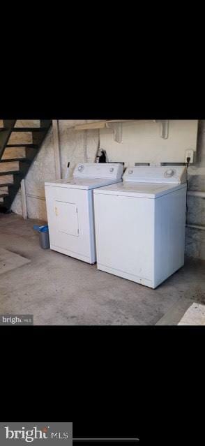 clothes washing area featuring washer and clothes dryer