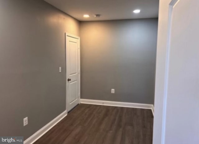 empty room featuring dark wood-type flooring