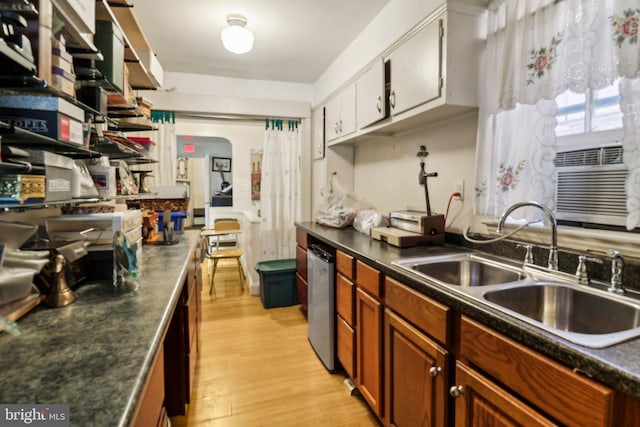 3536 Minnesota Ave SE, Washington, DC 20019 - kitchen featuring dark countertops, light wood-type flooring, brown cabinets, dishwasher, and cooling unit