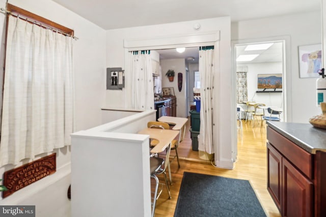 3536 Minnesota Ave SE, Washington, DC 20019 - kitchen with light wood-style flooring, dark brown cabinets, and electric panel