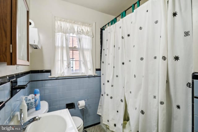 3536 Minnesota Ave SE, Washington, DC 20019 - bathroom with curtained shower, wainscoting, and tile walls