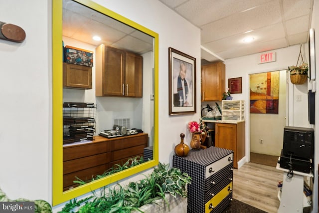 3536 Minnesota Ave SE, Washington, DC 20019 - kitchen featuring light wood-style floors, light countertops, brown cabinetry, recessed lighting, and a paneled ceiling