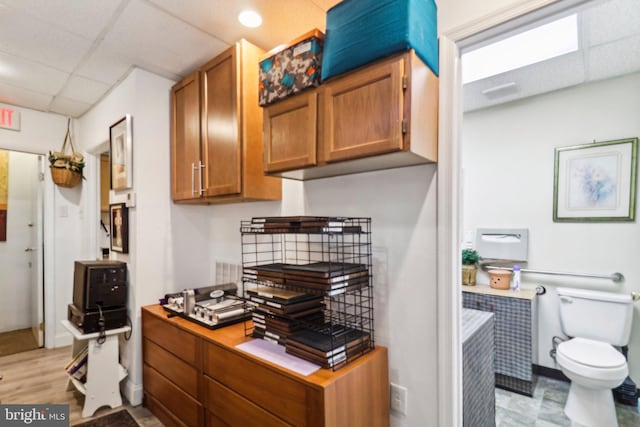 3536 Minnesota Ave SE, Washington, DC 20019 - kitchen with a paneled ceiling, brown cabinetry, light countertops, and a desk