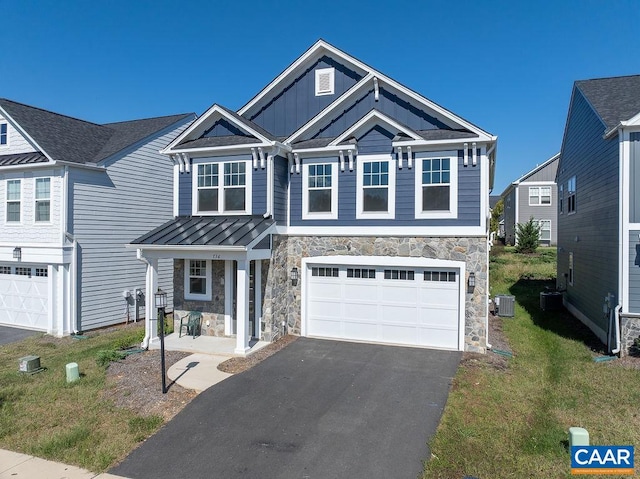 view of front of home featuring a garage, central AC, and a front yard