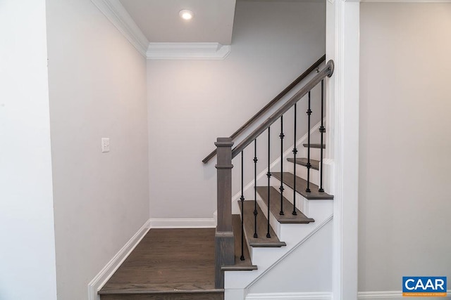 staircase featuring wood-type flooring and crown molding