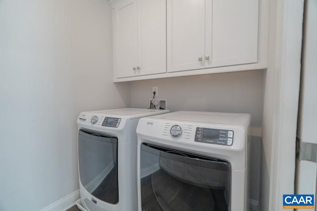 clothes washing area featuring cabinets and washing machine and clothes dryer