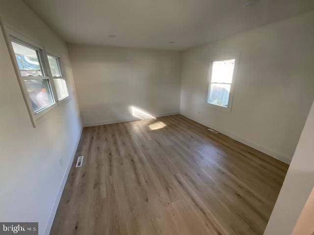 unfurnished room with light hardwood / wood-style flooring