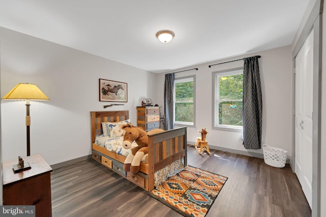 bedroom featuring a closet and dark hardwood / wood-style flooring