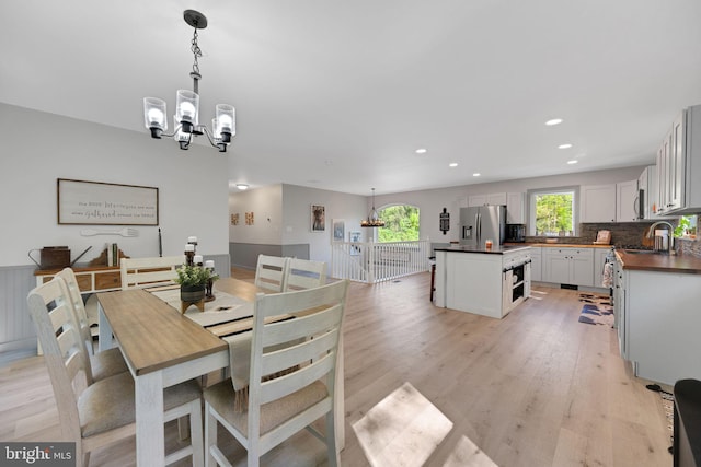 dining space featuring a notable chandelier and light hardwood / wood-style flooring